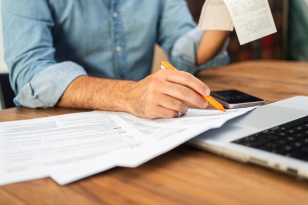man-in-a-denim-shirt-calculating-taxes-with-receip-2024-12-10-00-21-41-utc (1)